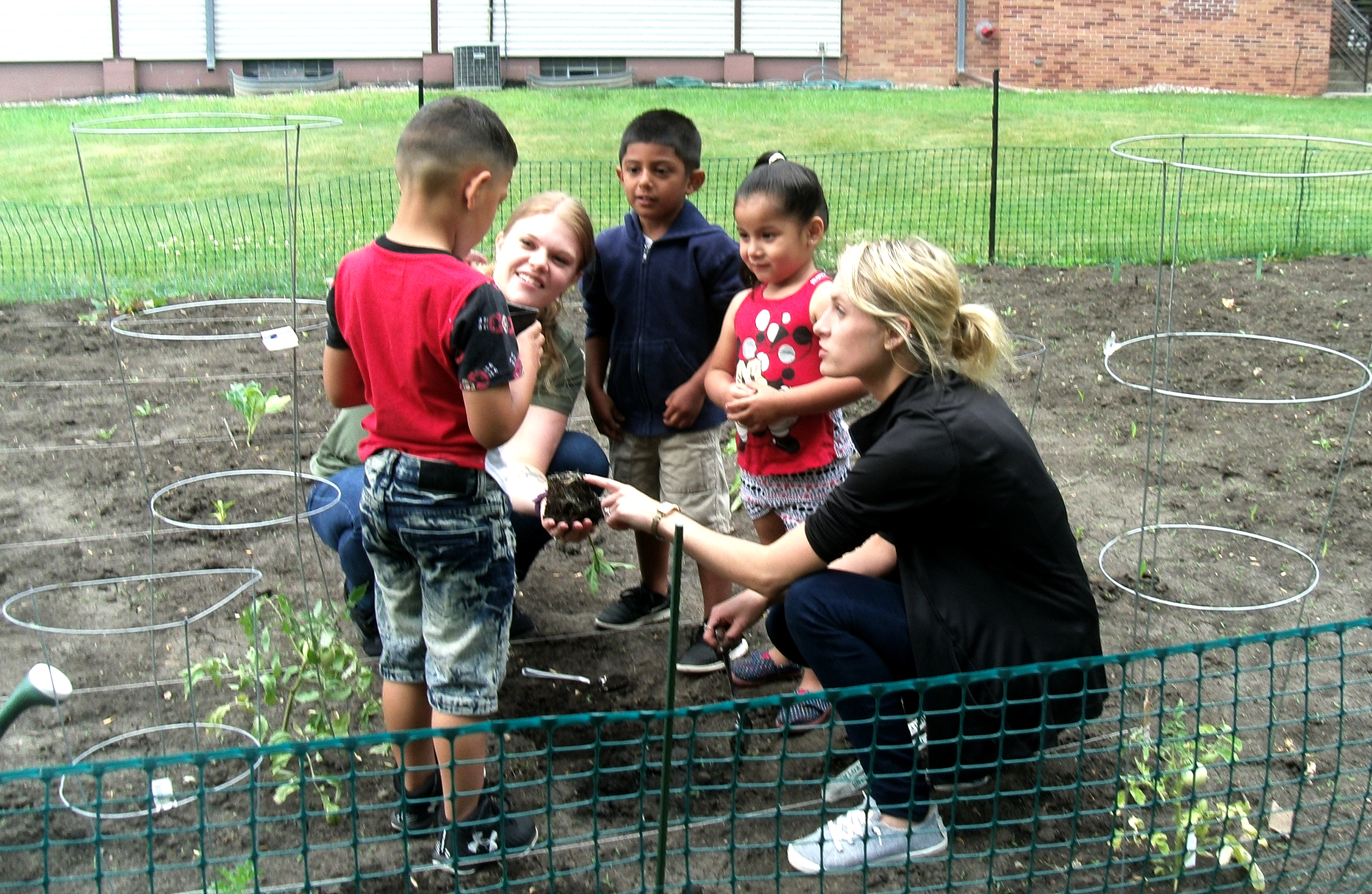 Jami working in the garden with the Head Start kids