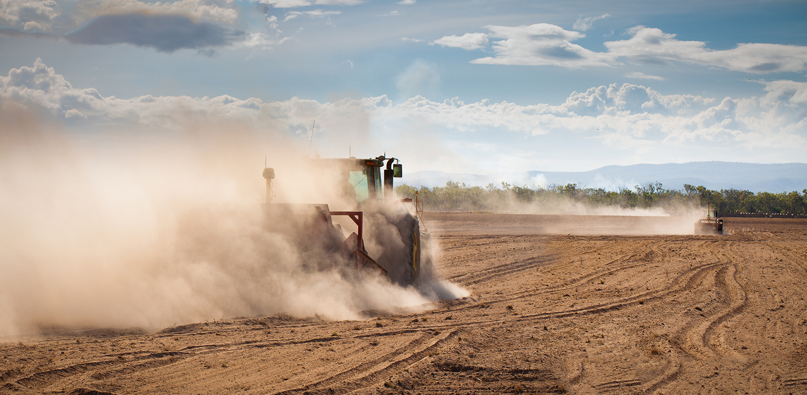 Tractor in a dry, dusty field