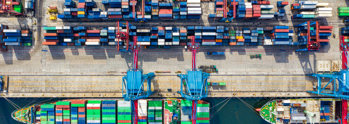 aerial view of barges and shipping containers at a dock