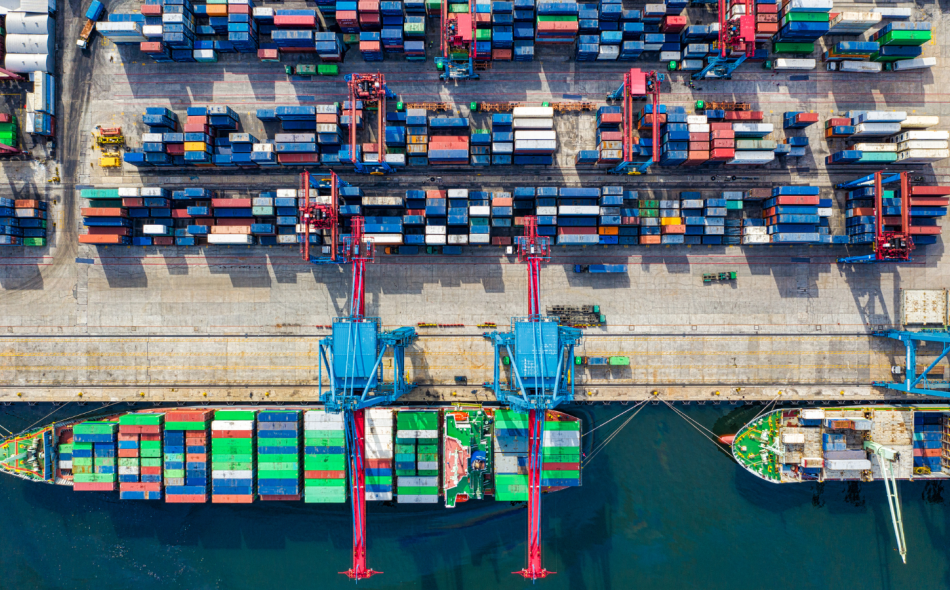 aerial view of barges and shipping containers at a dock