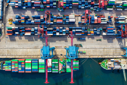 aerial view of barges and shipping containers at a dock